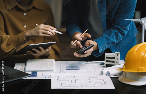brainstorming and measuring for cost estimating on paperworks and floor plan drawings about design architectural and engineering for houses and buildings.