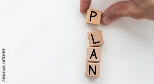 Plan concept. Hand holding a Wooden block with text on table. Copy space