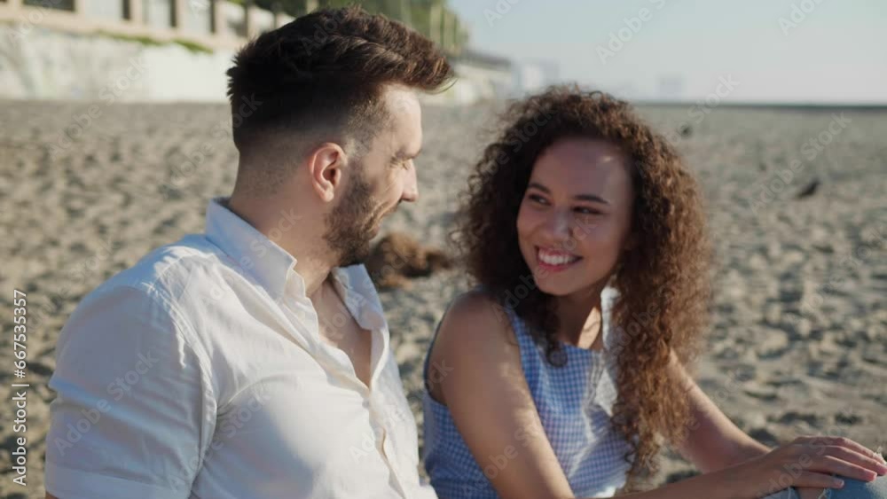 Happy couple enjoying time together on beach at sunset, slow motion effect Happy couple enjoying time together on beach at sunset, slow motion effect