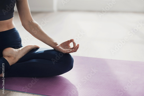 Yoga woman meditating and practicing yoga at home or yoga studio. Recreation, self care, self acceptance, meditation, relaxation, healthy lifestyle, mindfulness concept