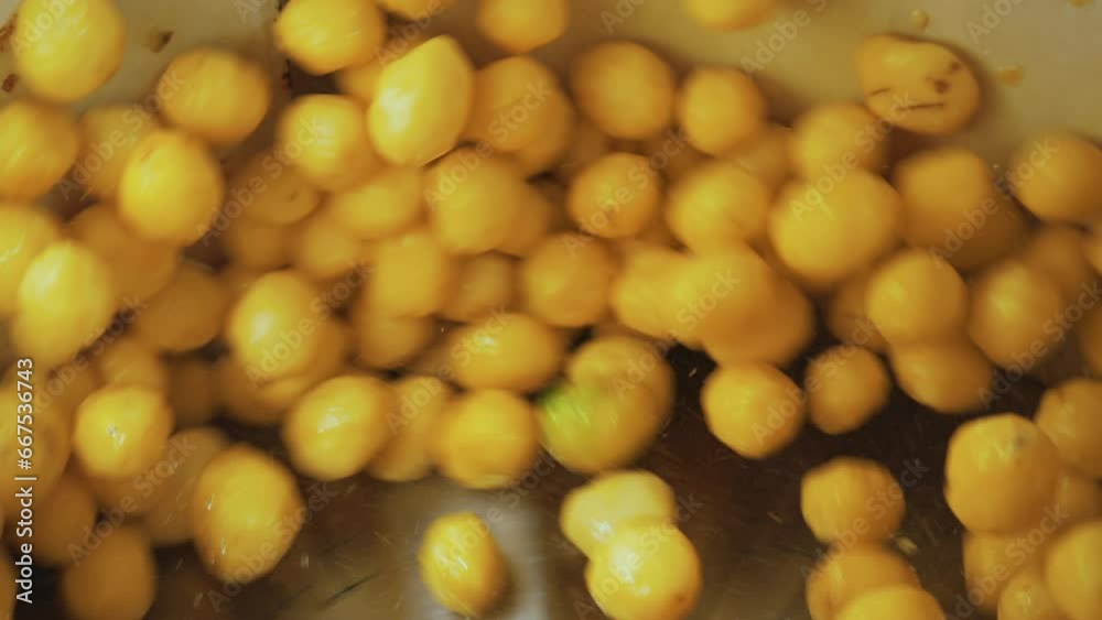 Closeup shot of potatoes being tossed around in an industrial machine for washing vegetables. Food industry concept. High quality 4k footage Closeup shot of potatoes being tossed around in an industrial machine for washing vegetables. Food industry concept. High quality 4k footage