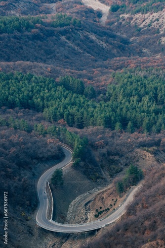 Winding roadway passes through a rural landscape.