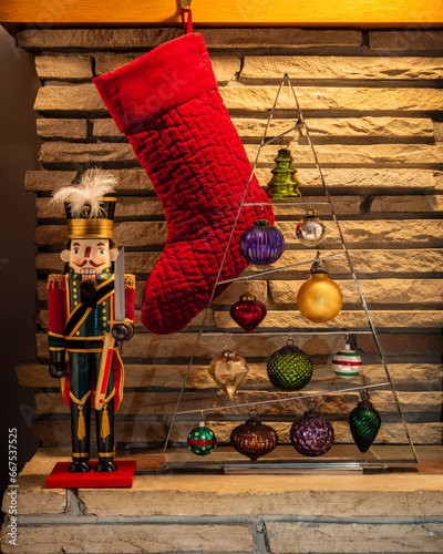 red christmas stocking with nutcracker and ornaments (ID: 667537525)