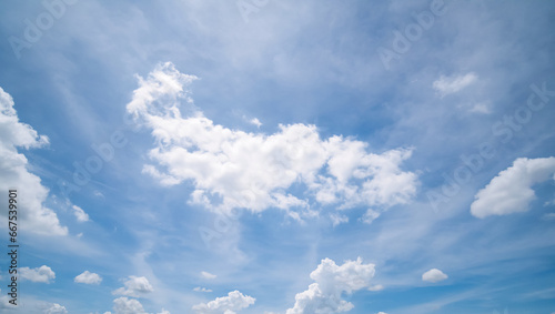 Fototapeta Naklejka Na Ścianę i Meble -  Panoramic view of clear blue sky and clouds, Blue sky background with tiny clouds. White fluffy clouds in the blue sky. Captivating stock photo featuring the mesmerizing beauty of the sky and clouds.