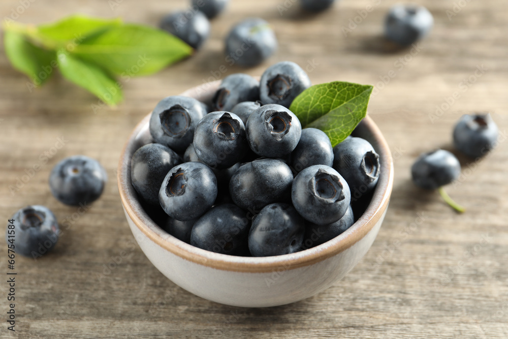 Bowl of tasty fresh blueberries on wooden table, closeup Bowl of tasty fresh blueberries on wooden table, closeup
