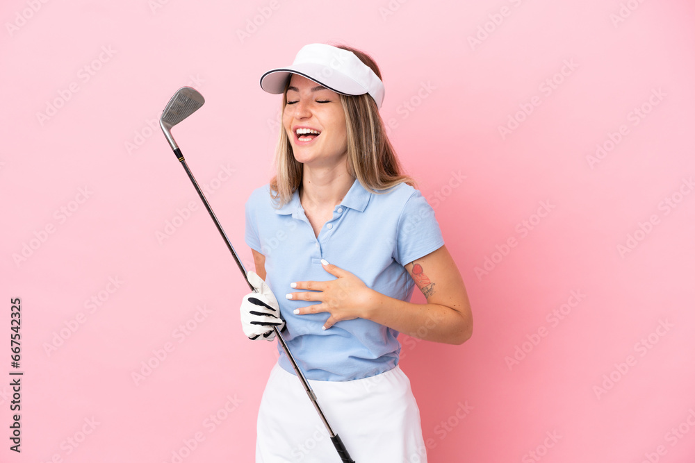 Young golfer player woman isolated on pink background smiling a lot Young golfer player woman isolated on pink background smiling a lot