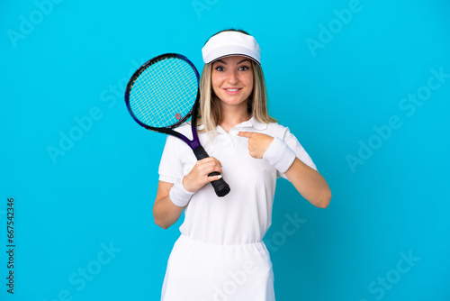 Young tennis player Romanian woman isolated on blue background with surprise facial expression © luismolinero