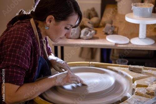 Young female potter working in her workshop in Antibes in the south of France