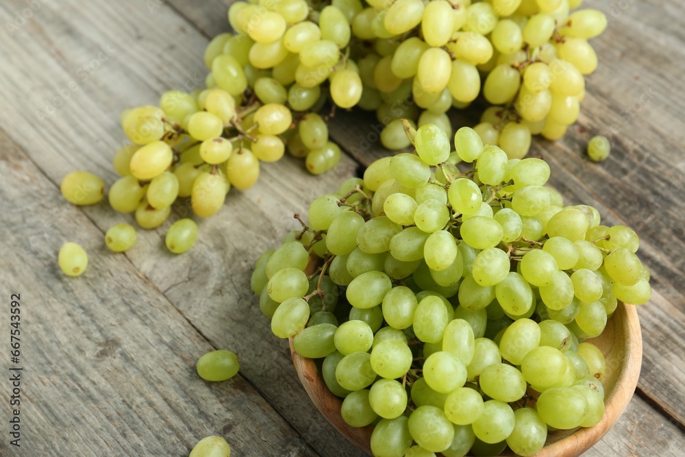 Delicious fresh green grapes on wooden table