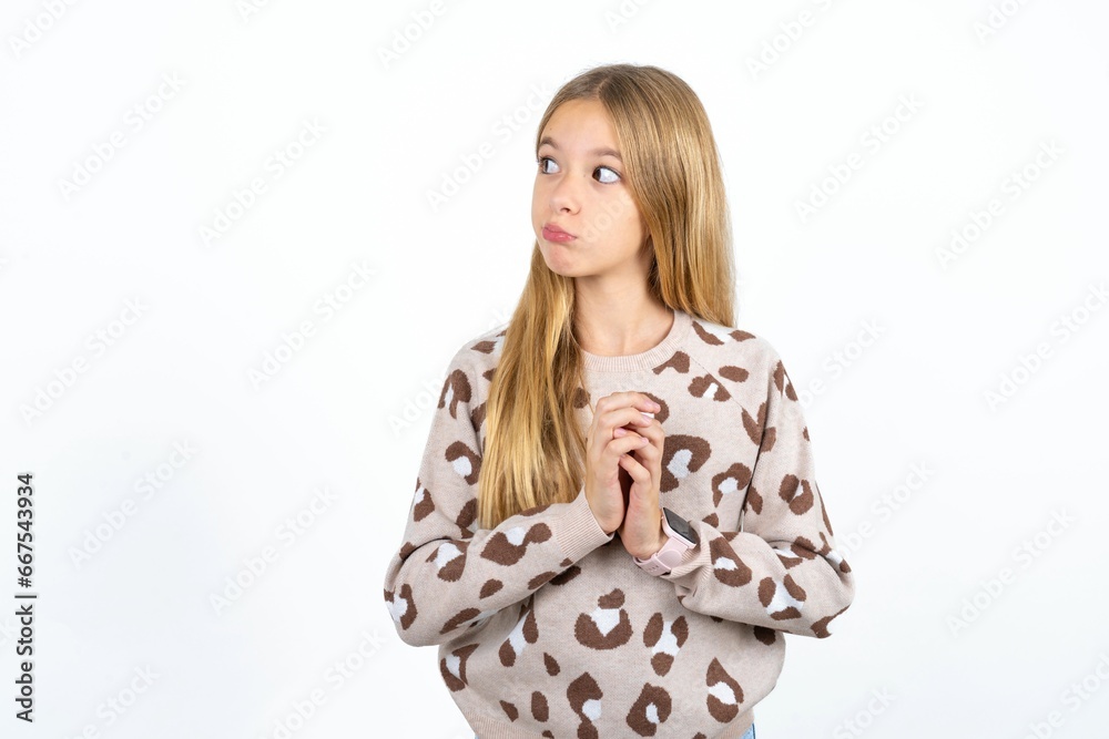 Charming cheerful Beautiful teen blonde girl  making up plan in mind holding hands together, setting up an idea.