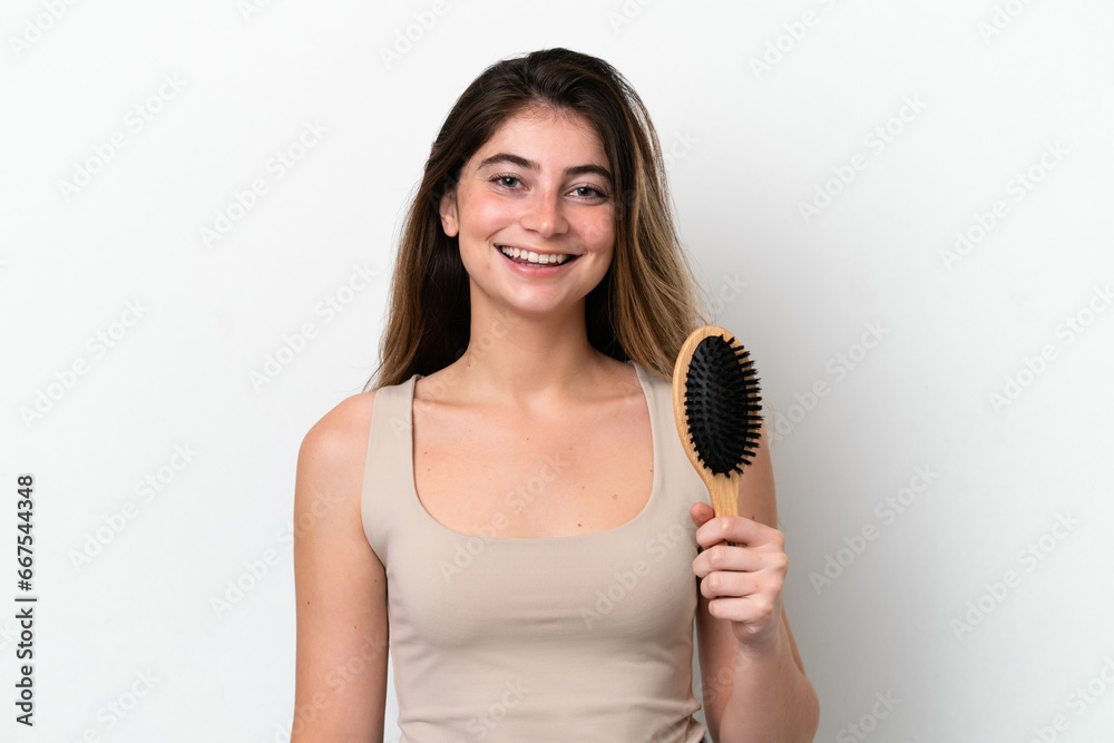 Young woman with hair comb isolated on white background smiling a lot Young woman with hair comb isolated on white background smiling a lot