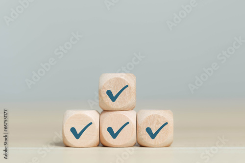 Wooden blocks display checkmarks to summarize task details and compile lists, votes, and to-do lists. Checklists, task lists, lists, and summaries Select document checklists and online quality assessm
