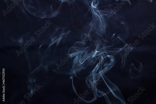 A lot of incense smoke on a dark background	
