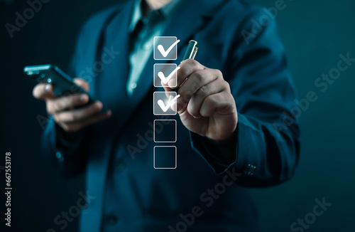 Businessman showing check mark summarizing job Compile lists, votes, and to-do lists. Checklists, task lists, and summaries description checklist Documents and online quality assessment standards
 photo