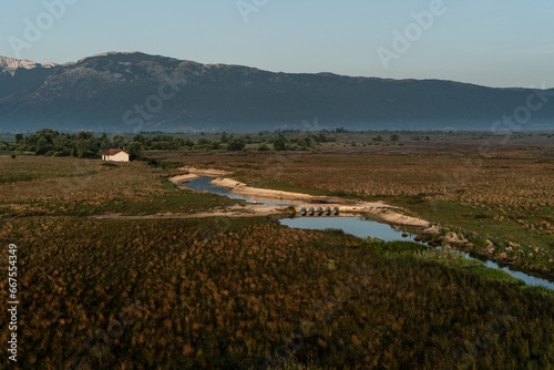 Aerial view of a small and old channel bridge next to the town Livno in Bosnia and Herzegovina. photo