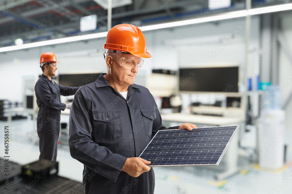 Workers inside a solar panel factory Workers inside a solar panel factory