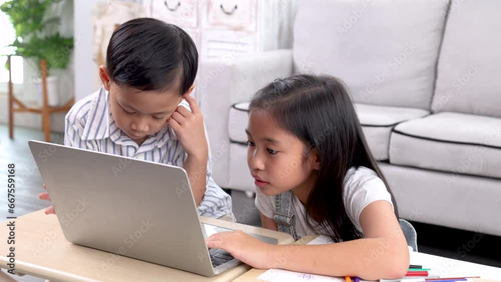 Addicted laptop video games online internet modern technology little sibling children watching together sitting on floor, happy emotional Asian boy and girl kids have fun leisure bonding relationship Addicted laptop video games online internet modern technology little sibling children watching together sitting on floor, happy emotional Asian boy and girl kids have fun leisure bonding relationship