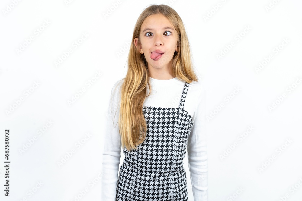 Funny MODEL makes grimace and crosses eyes plays fool has fun alone sticks out tongue.
