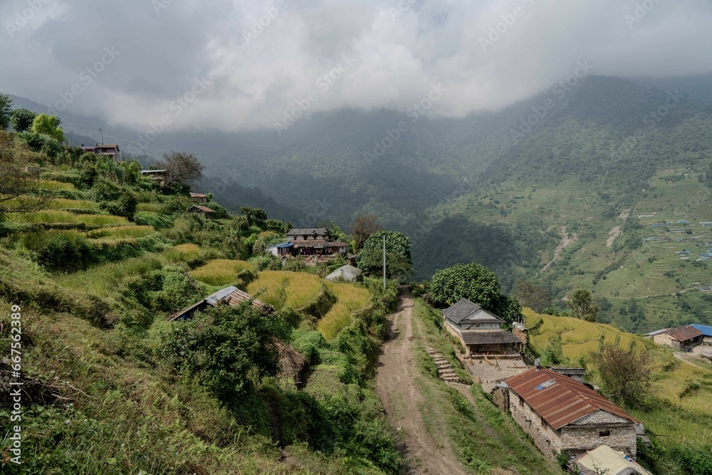 Fototapeta premium a view of a village and mountain area with a valley