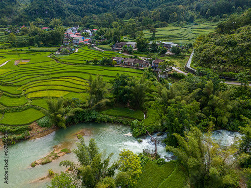 Aerial landscape in Quay Son river, Trung Khanh, Cao Bang, Vietnam with nature, green rice fields and rustic indigenous houses