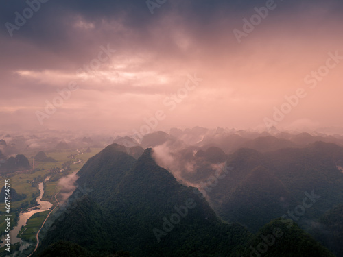 Aerial view of dawn on mountain at Ngoc Con ward, Trung Khanh town, Cao Bang province, Vietnam with river, nature, green rice fields. Near Ban Gioc waterfall.