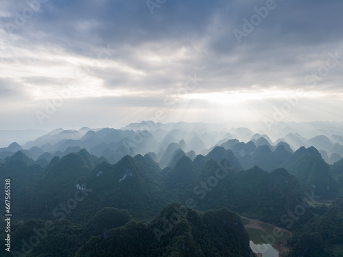 Aerial view of Thung mountain in Tra Linh  Cao Bang province  Vietnam with lake  cloudy  nature.