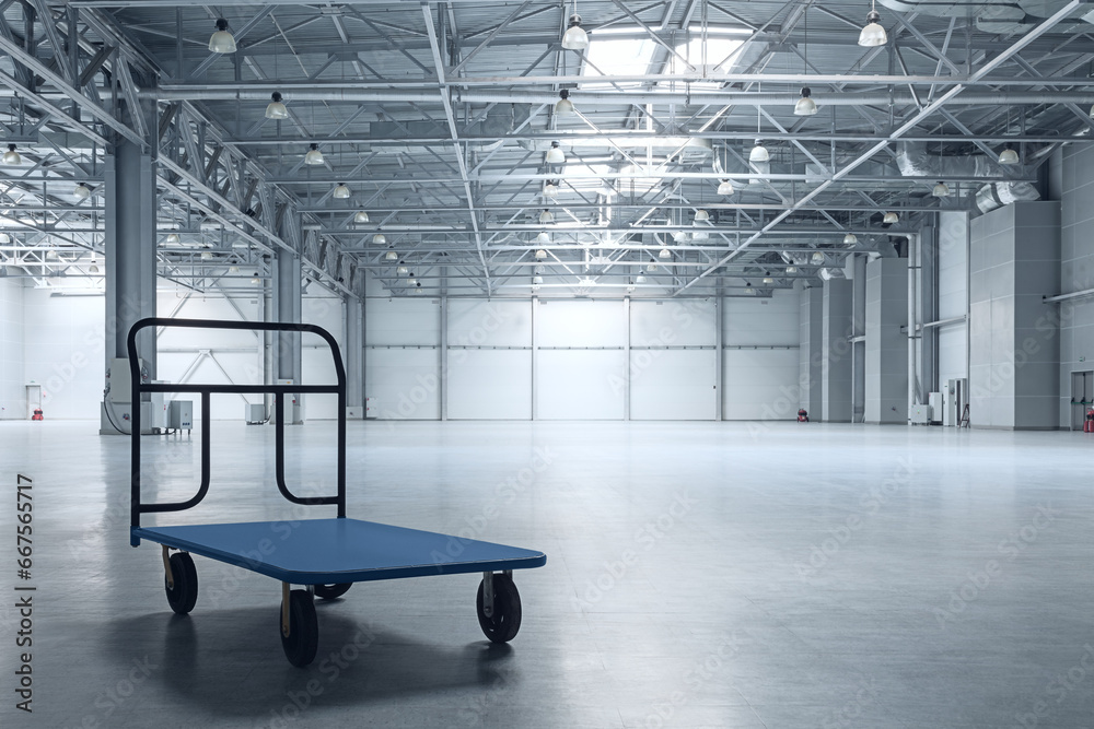 Interior of empty warehouse with a cart