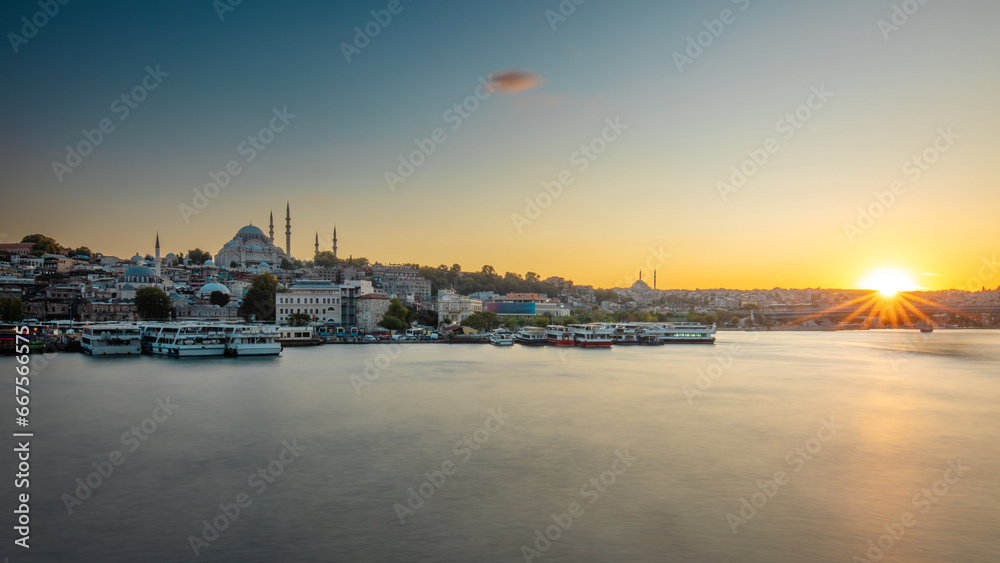 Sunset over the Golden Horn Bridge and the Suleymaniye Mosque. Istanbul, Turkey.