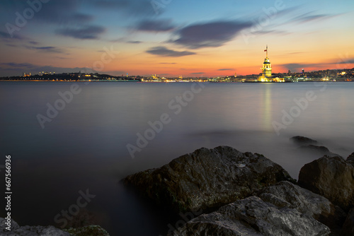 Illuminated Maiden Tower and Istanbul panorama at sunset, Turkey