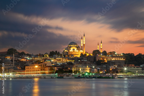 Historic Suleymaniye Mosque at dusk and the Golden Horn with ferries. Istanbul, Turkey. © mikelaptev