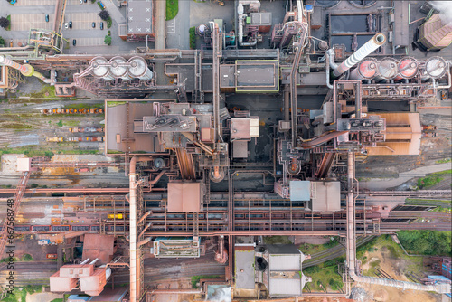 Steel factory from above. Overhead view of a vibrant steel production center with a myriad of activities taking place, highlighting the various stages of steel production.