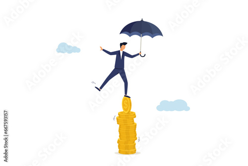 Economic problems, balance or reliability, money management, financial stability, risk or trust, security or wealth accumulation concept, businessman holding umbrella balance on unstable stack of coin