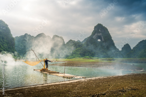 view of fishermen fishing on river in Thung mountain in Tra Linh, Cao Bang province, Vietnam with lake, cloudy, nature