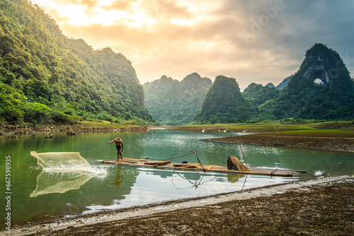 view of fishermen fishing on river in Thung mountain in Tra Linh, Cao Bang province, Vietnam with lake, cloudy, nature photo