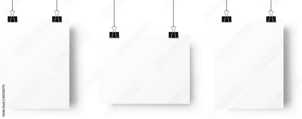 A4 paper page blank posters hanging on paperclip. Realistic mockup  - obrazy, fototapety, plakaty 