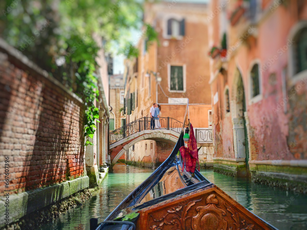 View from the front of the gondola to Venice canals, architecture and the bridge over the canal. - obrazy, fototapety, plakaty 