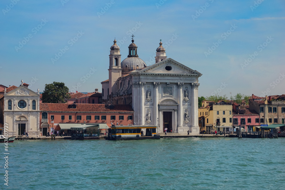 View from the window of the catamaran on the Venetian lagoon and the architecture of Venice, Italy.