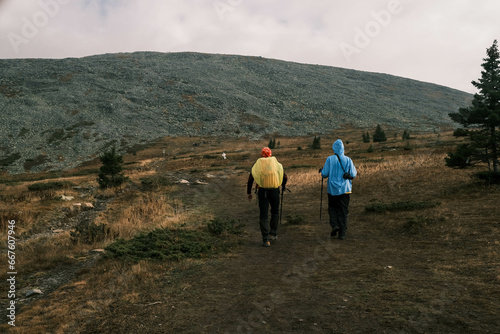 active lifestyle.Tourists with backpacks are walking over rough terrain in the mountains.Mountain tourism