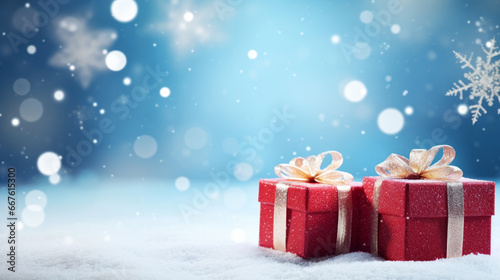 Gift boxes in snow with bokeh background. Christmas and New Year concept. © pixelliebe