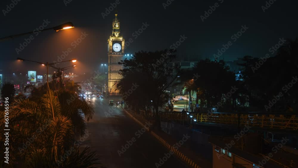 Timelapse view of traffic in front of architectural landmark Lake Town Clock Tower at night in Kolkata, West Bengal, India.