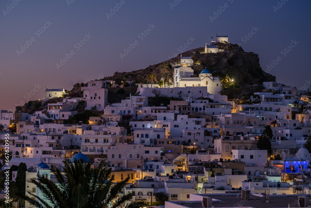 Panoramic view of the picturesque illuminated island of Ios in Greece at sunset