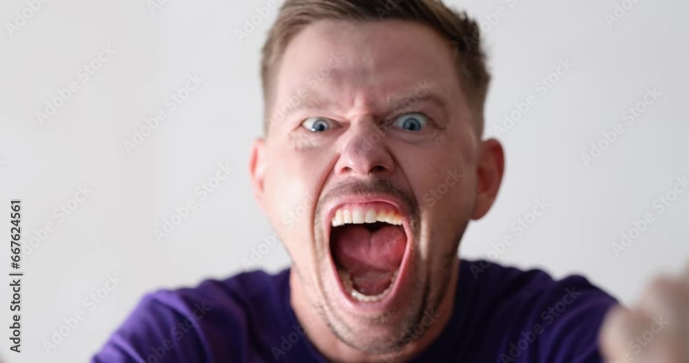 Portrait of screaming angry young handsome man. Men emotions of anger irritation and dissatisfaction concept
