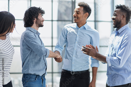 Successful Business Collaboration: Executives Greet with Handshake in Office