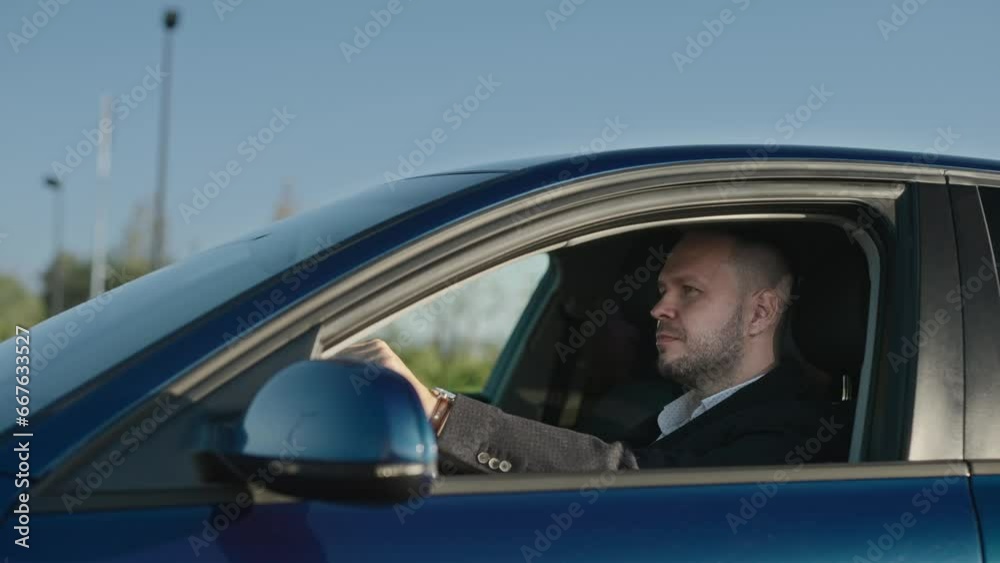 Businessman drives his car. An elegant adult man is driving home after work.