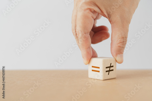 Hand flipping wooden unequal  to equal wooden cube blocks including copy space. For rights , gender equality concept photo