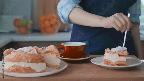 Woman at kitchen tasting traditional Karpatian cake photo