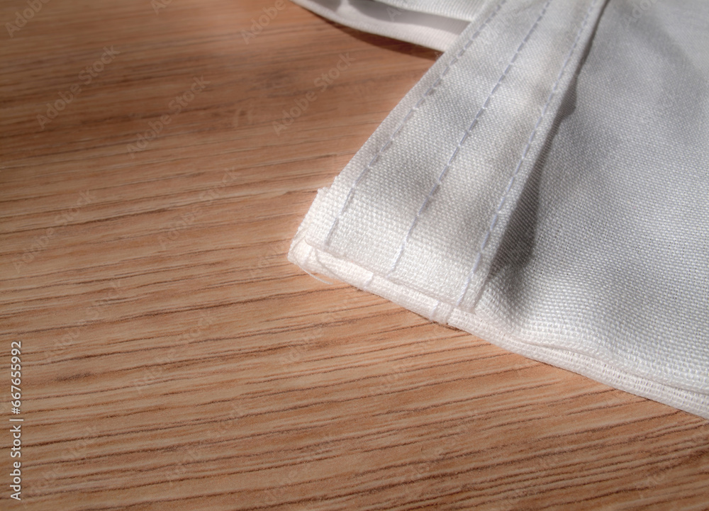 Fabric shopping bag detail. On wooden floor, with space for text. Fabric packaging option for organic products. Fabric shopping bag detail. On wooden floor, with space for text. Fabric packaging option for organic products.