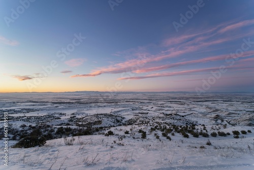 Spectacular snowy landscape from the top of a mountain at sunset.