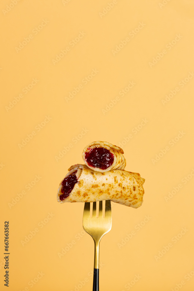 French Crepes with berry jam on fork food concept