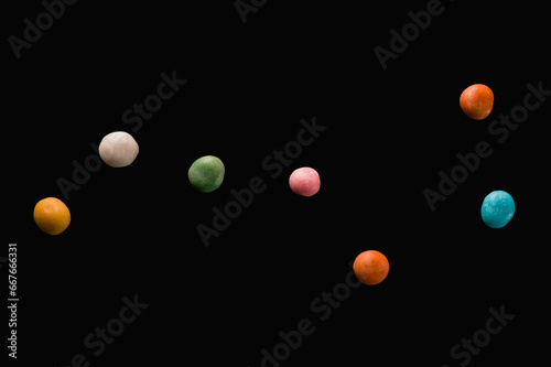 The Big Dipper constellation made of colored candies on a black background